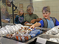  kids selecting food items in a lunch line